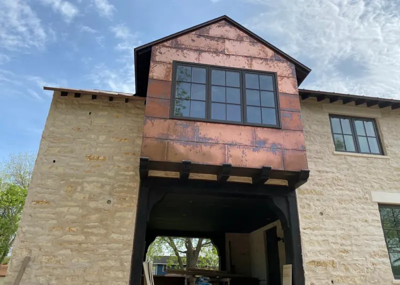 Copper metal panel facade on a stone building for Skylight Installation in West Goshen